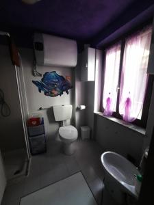 a bathroom with a fish balloon above a toilet at casa RIVER in Scopello