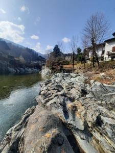 a river with rocks next to the water at casa RIVER in Scopello