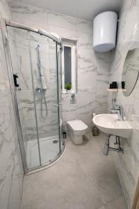 a bathroom with a shower and a toilet and a sink at Msida Modern & Bright 2-Bedroom Apartment in Msida