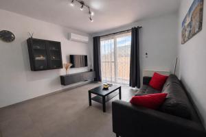 a living room with a couch and a table at Msida Modern & Bright 2-Bedroom Apartment in Msida