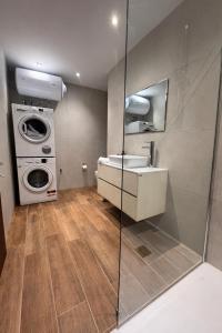 a bathroom with a sink and a washing machine at Msida Modern & Bright 2-Bedroom Apartment in Msida
