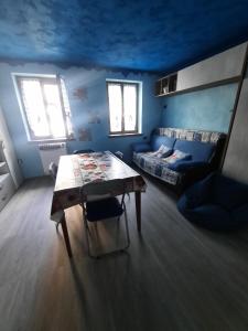 a living room with a table and a couch at casa RIVER in Scopello +18 photos