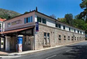 a brick building on the side of a street at Hostel 365 For U in Dubrovnik