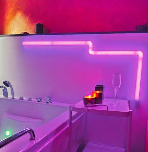 a bathroom with a tub with a glass of wine at Tudesia royal suite in Todi