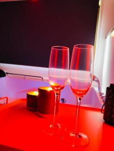 two wine glasses sitting on top of a table at Tudesia royal suite in Todi +34 photos