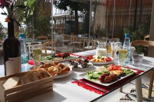 a table with three plates of food on it at Hotel Brilant in Shëngjin