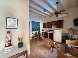 a kitchen and living room with a table and a refrigerator at St. Francis Suite in San Juan del Sur