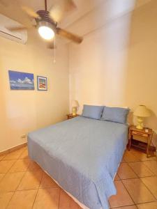 a bedroom with a bed with blue pillows at St. Francis Suite in San Juan del Sur