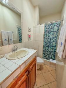 a bathroom with a sink and a toilet and a shower at St. Francis Suite in San Juan del Sur +37 photos