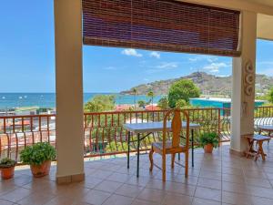 a balcony with a table and chairs and a view of the ocean at St. Francis Suite in San Juan del Sur