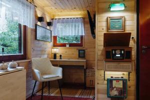 a tiny house with a desk and a chair at Hishka Ishka Love in Iška