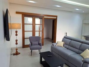 a living room with a blue couch and a chair at Elegant 3-room apartment in Dakar