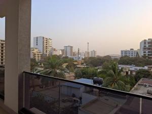 a view of a city from the balcony of a building at Elegant 3-room apartment in Dakar