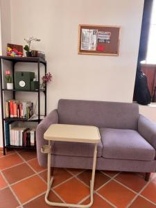 a living room with a couch and a table at Hostal Boutique Loto de Belén in Bogotá