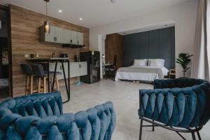 a bedroom with a bed and a table and chairs at Nomadic Boutique Living and Experience Center in Medellín