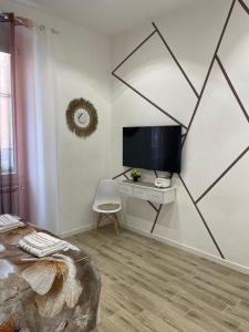 a bedroom with a tv and a desk with a chair at Casa Rebocco in La Spezia