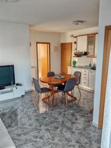 a kitchen and dining room with a table and chairs at Apartma S&M in Koper