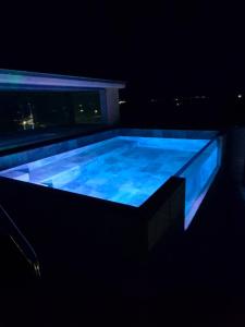 a large swimming pool lit up at night at Concejo Hospederia in Valoria la Buena