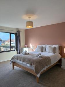 a bedroom with a large bed with a large window at Arcadia - Kirkwall in Orkney