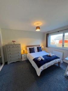 a bedroom with a large bed and a window at Arcadia - Kirkwall in Orkney