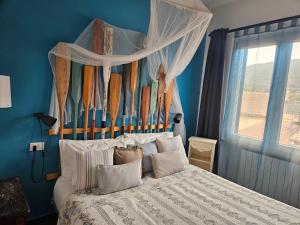 a bedroom with a bed with surfboards on the wall at VILLA VILLACOLLE in Procchio