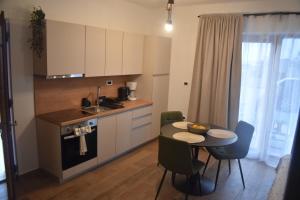 a kitchen with a small table and a table and chairs at Vinea Nature in Brkač
