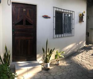 a door of a house with plants in front of it at Habitación orégano in Santa Elena