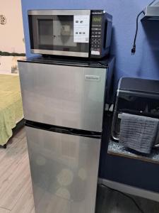 a microwave oven sitting on top of a refrigerator at Small's Cozy Rest 9 Efficiency in South Bimini