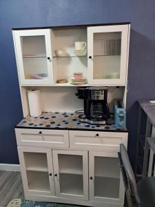 a toy kitchen with white cabinets and a coffee maker at Small's Cozy Rest 9 Efficiency in South Bimini