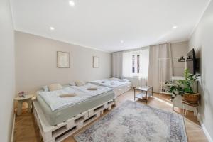 a bedroom with two beds and a rug at Haban Haus in Bratislava