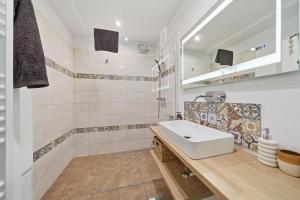a white bathroom with a sink and a shower at Haban Haus in Bratislava +16 photos