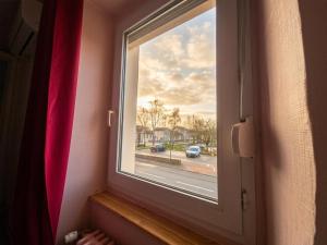 a window in a room with a view of a street at Chez ValJean in Châlus