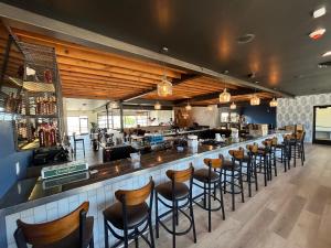 a bar with a row of stools in a restaurant at The Painted Pelican in Luxemburg