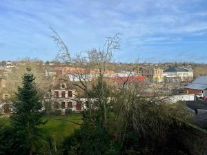 a view of a city with houses and trees at Appartements Lambotte in LʼAigle