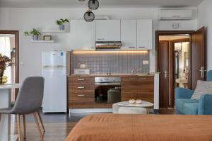 a kitchen and living room with a couch and a refrigerator at Rooms & Apartments 72 in Zadar