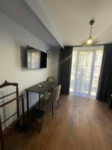 a living room with a table and a table and chairs at Villa Rinat Boutigue Hotel in Kyiv