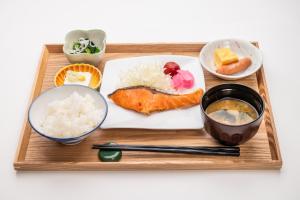 a tray of food with sushi and rice and chopsticks at 大和パークホテル in Taiwa