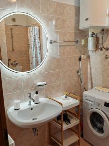 a bathroom with a sink and a washing machine at Apartma S&M in Koper +10 photos