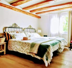 a bedroom with a large bed and a window at Casa La Sendera Alojamiento Rural en La Rioja in Santa Engracia +6 photos