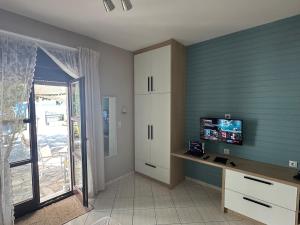 a room with a desk and a tv and a window at Sea You - Apartments in Avlákia