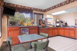 a large kitchen with a table and chairs at Days Inn by Wyndham Dublin GA in Dublin