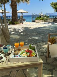 a tray of food on a table with a plate of fruit at Sea You - Apartments in Avlákia