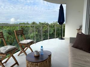 a living room with a couch and chairs on a balcony at Victoria's home near the beach with Swimming pool and elevator in Punta Cana