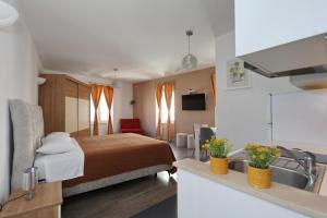 a hotel room with a bed and a sink at Rooms & Apartments 72 in Zadar