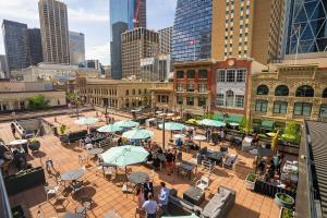 a group of people walking around a patio in a city at Calgary Marriott Downtown Hotel in Calgary