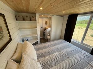 a bedroom with a bed in a tiny house at Mountain View Retreat in Creston