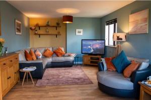 a living room with a couch and a television at Inskeyft - Kirkwall in Kirkwall