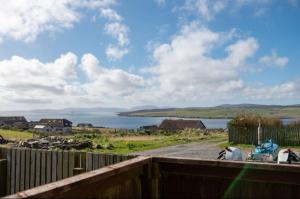 a view of a body of water with a fence at Inskeyft - Kirkwall in Kirkwall