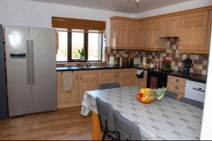 a kitchen with a table with a bowl of fruit on it at Inskeyft - Kirkwall in Kirkwall