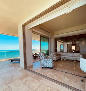 a living room with a view of the ocean at Ocean Wrap Around Oceanfront Balcony at Tessoro in Las Conchas